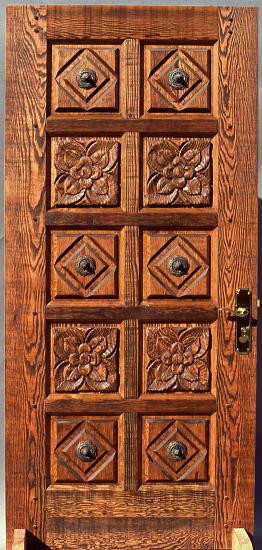 Carved rustic fir door with Mexican rossetts