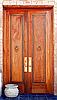 Tall mahogany doors with copper